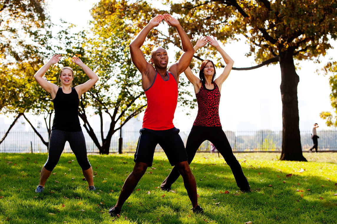 Three Young Adults Exercising in the Park